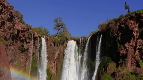 Waterfall cascading down the mountainside creating rainbow 3 스톡 동영상 148027050