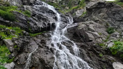 Waterfall cascading down mountainside Stock Footage 311872660