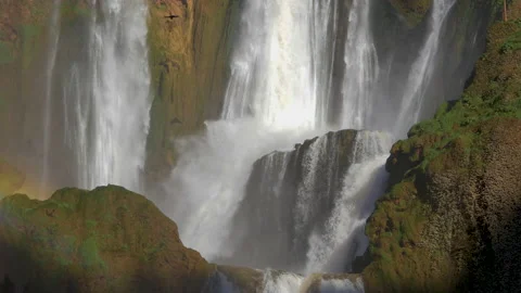 Waterfall cascading down the mountainside in slow motion Stock Footage 148027320