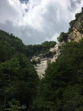 Waterfall cascading down rock cliff La Vall d'en Bas Catalonia Stock Photos