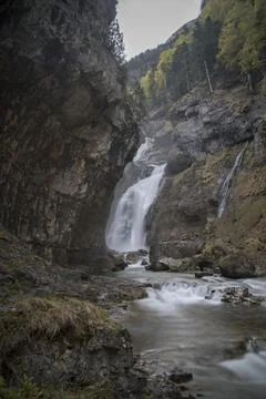 Waterfall cascading down rock cliffs in ordesa national park Stock Photos