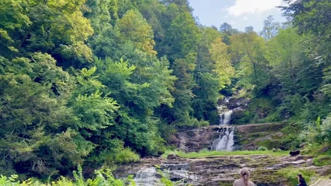 Waterfall Cascading Down Rock Ledges in Forest Wide Shot Stock Footage 344812007