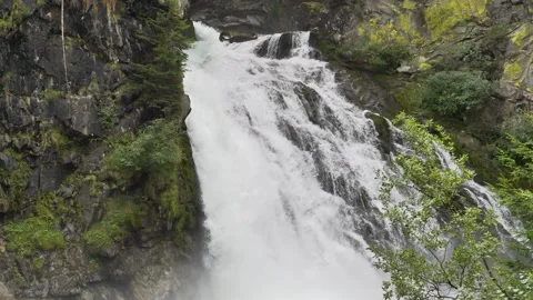 Waterfall cascading down rocky cliff in nature Stock Footage 285264416