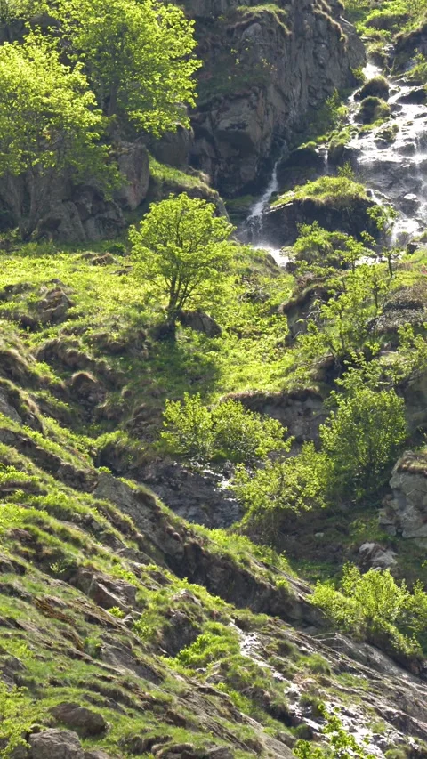 Waterfall Cascading Down Rocky Cliffs Near Lago della Rovina Stock Footage 341299386