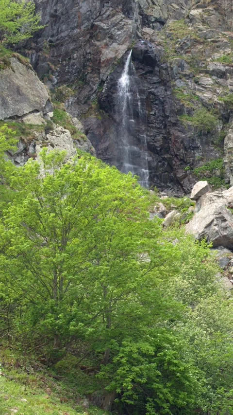 Waterfall Cascading Down Rocky Cliffs at Lago della Rovina Stock Footage 341322743