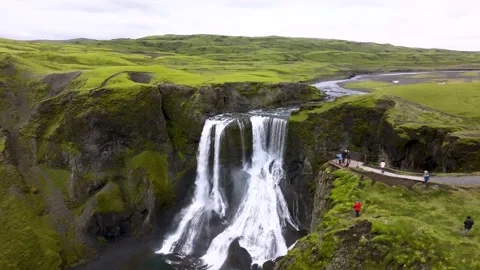Waterfall cascading down rocky cliffs into an Icelandic valley Stock-Footage 341328081