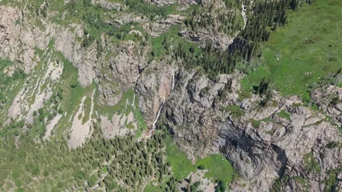 Waterfall cascading down rocky mountainside in summer Stock-Footage 312435668