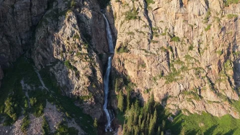 Waterfall cascading down rocky mountainside in natural landscape Video stock 312446208