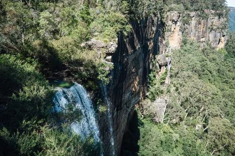 Waterfall cascading over cliffs at Fitzroy Falls, Australia Stock Photos