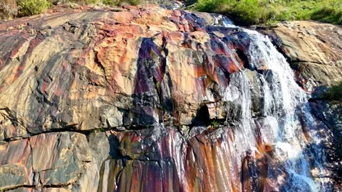 Waterfall cascading over colorful rocks Video stock 296542284