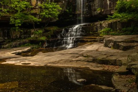 Waterfall cascading over mountainside Stock Photos