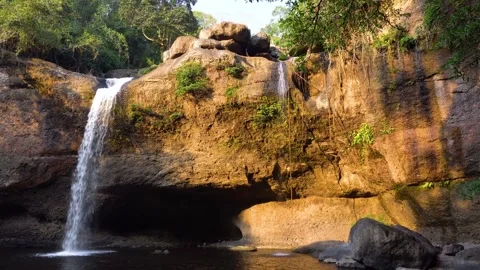 Waterfall cascading over rocks with jungle. Stock Footage 305862736