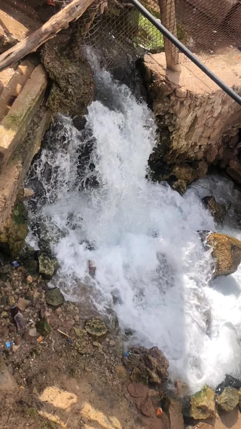 Waterfall Cascading Over Rocks in Natural Stream Stock Footage 330603380