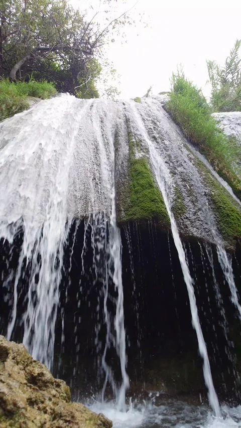 Waterfall Cascading Over Rocky Cliff In Green Forest - 4k Vertical Footage Stock Footage 343440101