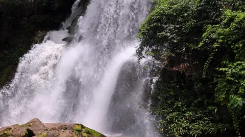 Waterfall Cascading Over Rugged and Rocky Terrain Surrounded by Natures Beauty. Stock Footage 305458898