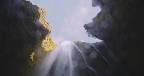 Waterfall Cascading From Sunlit Rocks Stock Footage 144661262