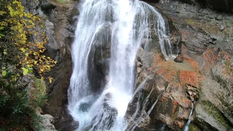 Waterfall Cascading Through Autumn Canyon with Golden Foliage. Stock Footage 344346465