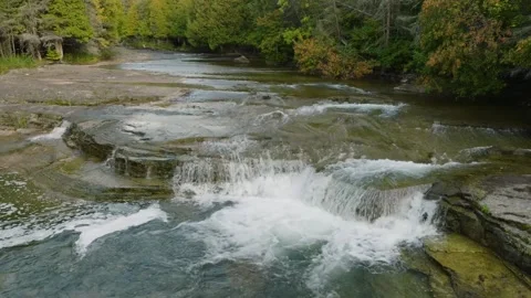 Waterfall cascading through the forest 库存影片 256941988