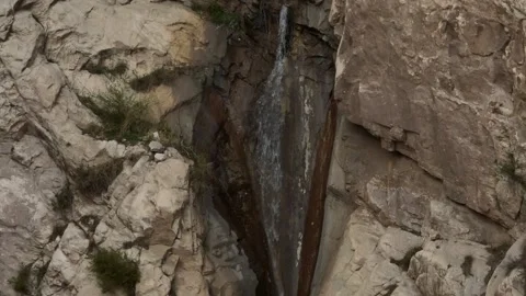 Waterfall Cascading Through Rocky Canyon Gorge Stock Footage 333577396