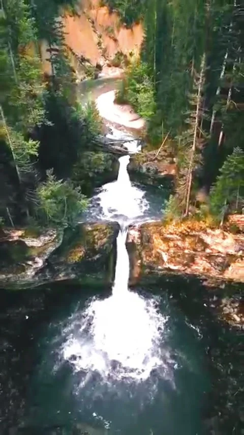 Waterfall Cascading Through Rocky Forest Gorge Stock Footage 337322897
