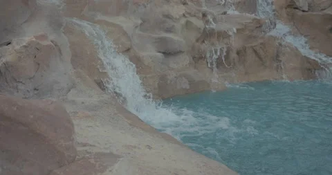 Waterfall cascading into tranquil turquoise pool 스톡 동영상 221290235