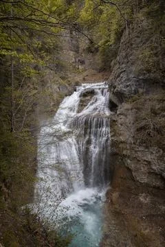 Waterfall cascading into turquoise pool in ordesa national park Stock Photos