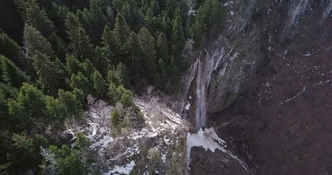 Waterfall on the cliffs at the edge of the forest Stock Footage 87353597