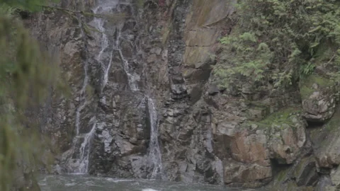 Waterfall on Cliffside Above River in Forest 스톡 동영상 219531038