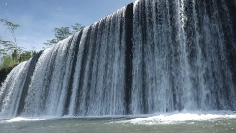 Waterfall close up slow motion on a blue sky background Stock Footage 123679445