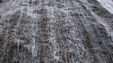 Waterfall close-up. The water flows down the steep stones. Video stock 232914920