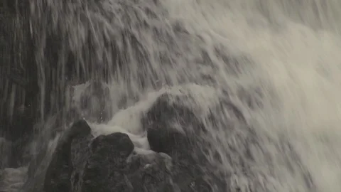 Waterfall. Close up of water hitting rocks with tilt up in slow motion Stock Footage 86829227