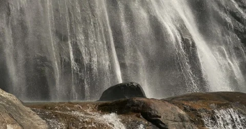 Waterfall closeup falling over polished stones Stock Footage 247643972