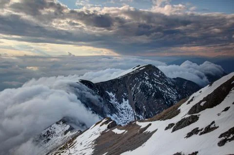 Waterfall-like clouds flowing down the steep Karavanke ridge Stock Photos