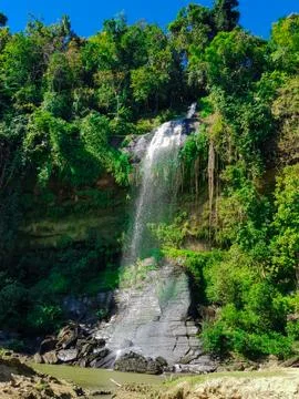 Waterfall coming down from a hill forest Stock Photos