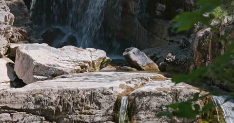 A waterfall covered by shadow and rays of light Stock Footage 204735476