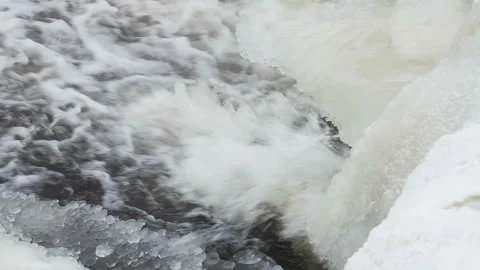 Waterfall is covered with thick white ice in winter Stock Footage 148408431
