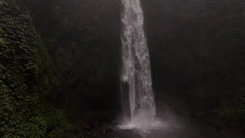 The waterfall crashed with force and power against the rocks in the jungle of Ba Stock Footage 279966916