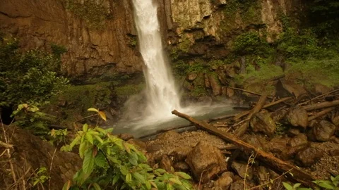 Waterfall crashing down into pool amongst rocks Stock-Footage 107652773