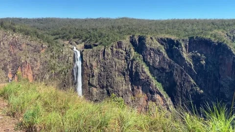 This waterfall creates mist at the base of sheer cliffs Stock Footage 340268036