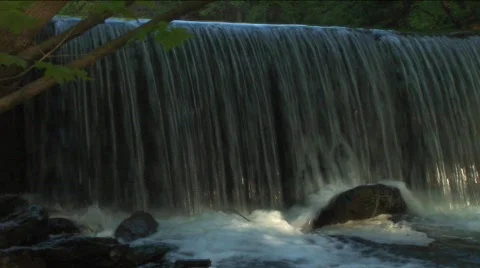 Waterfall into creek at dusk Stock Footage 311904