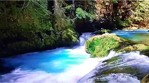 Waterfall in crystal clear river Stock Photos