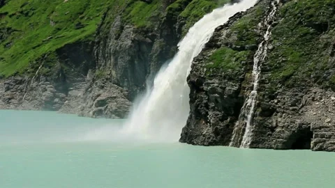 Waterfall, dam and Lac de Mauvoisin, Switzerland. Stock Footage 202137307