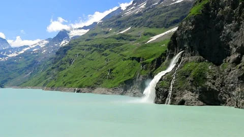 Waterfall, dam and Lac de Mauvoisin, Switzerland. Stock Footage 202138555