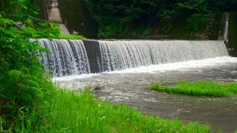 Waterfall dam river flow green beautiful nature calm village Stock Footage 265380087
