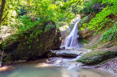 Waterfall in dark forest Stock Photos
