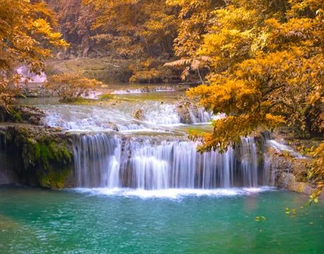 Waterfall in deep forest at erawan waterfall national park Stock Photos