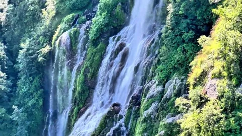 This waterfall descends through Nepal's terraced hill landscape Stock Footage 340267987