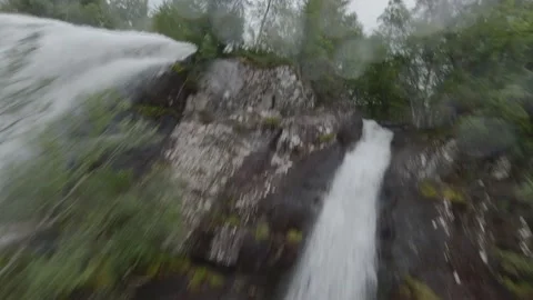 Waterfall dive under bridge Norway Stock Footage