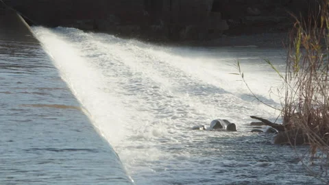 Waterfall at the diversion dam at the Salt River streaming into Lake Roosevelt Stock Footage 212869660