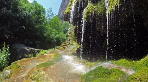 Waterfall dripping from mossy rocks Stock Footage 52063399